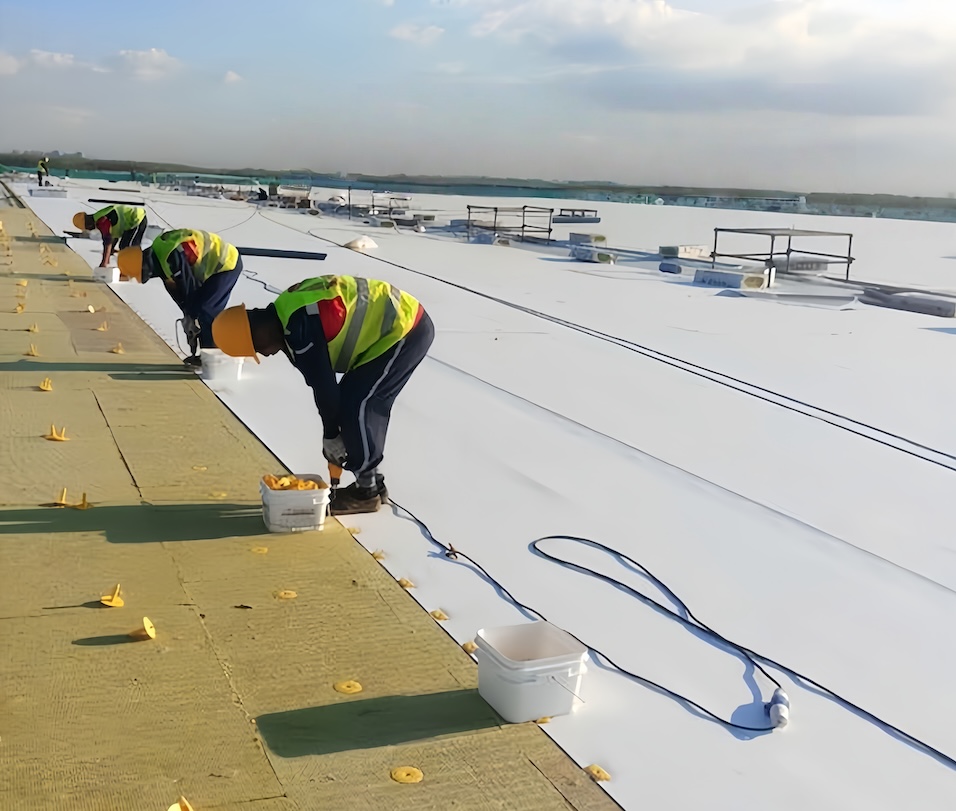 8685e389-e0b3-40de-8ece-4aa4138cb3b0_Worker installing ceiling rock wool insulation on scissor lift in industrial building.jpg
